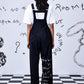 Stylera black relaxed fit dungaree for women back view wide leg trousers with white tee and leg graphic