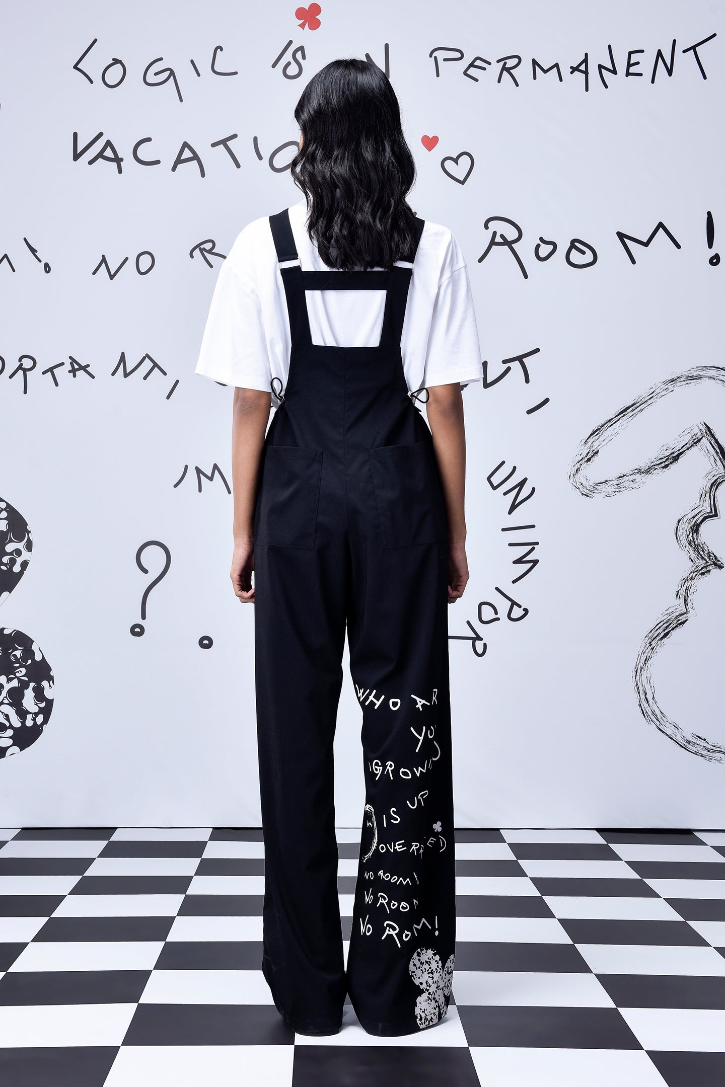 Stylera black relaxed fit dungaree for women back view wide leg trousers with white tee and leg graphic