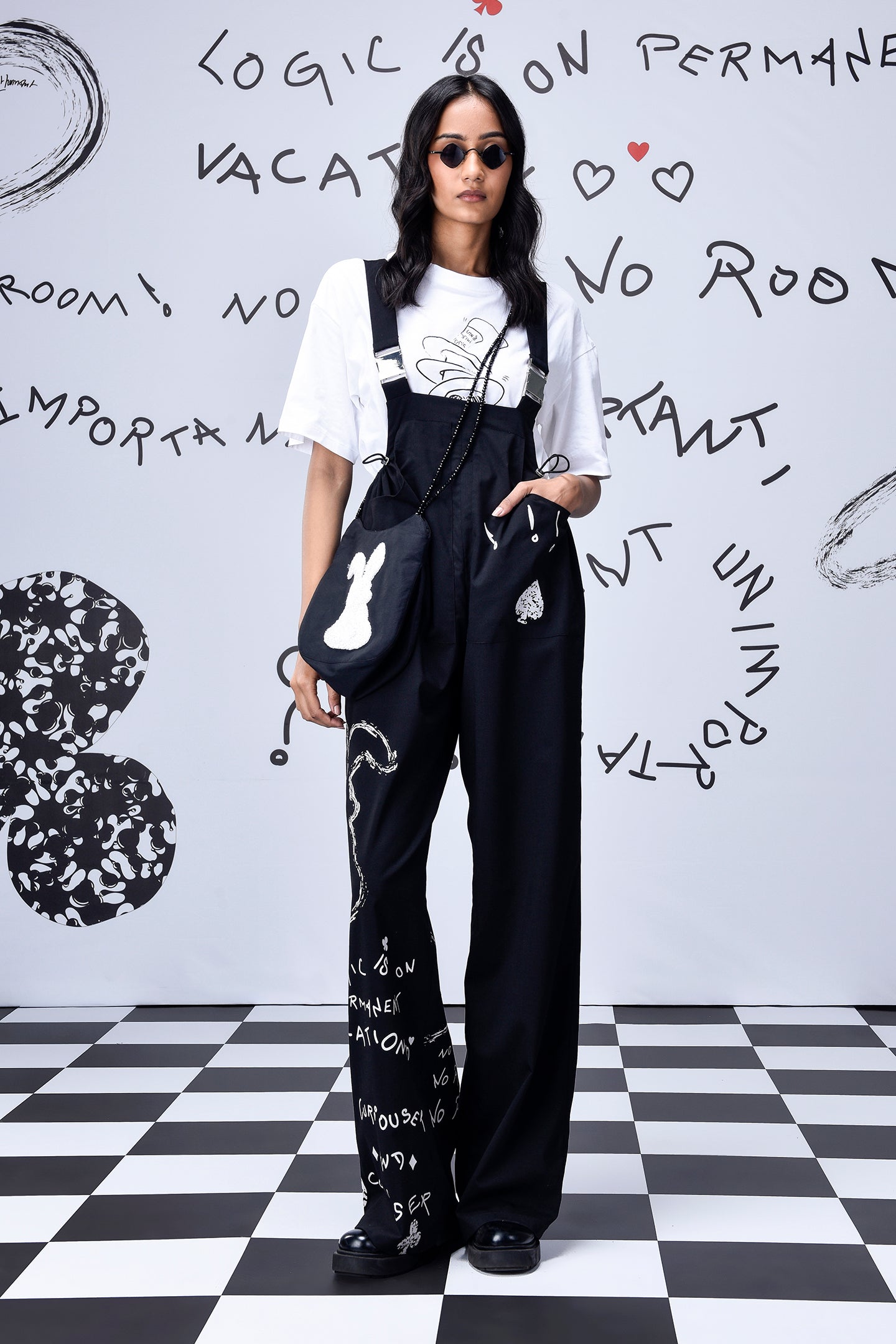 Stylera black printed relaxed fit dungaree for women styled with white tee and sunglasses