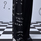 Stylera black graffiti wide leg relaxed fit dungaree for women shown over platform shoes on checkered floor
