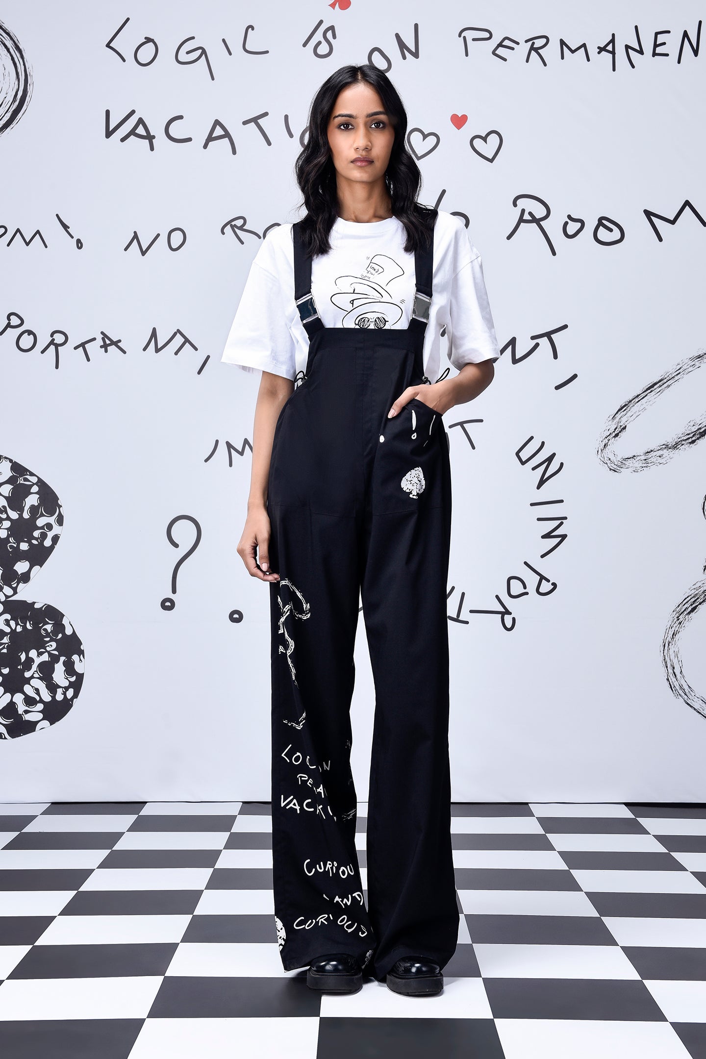Stylera black relaxed fit dungaree for women styled with white graphic tee