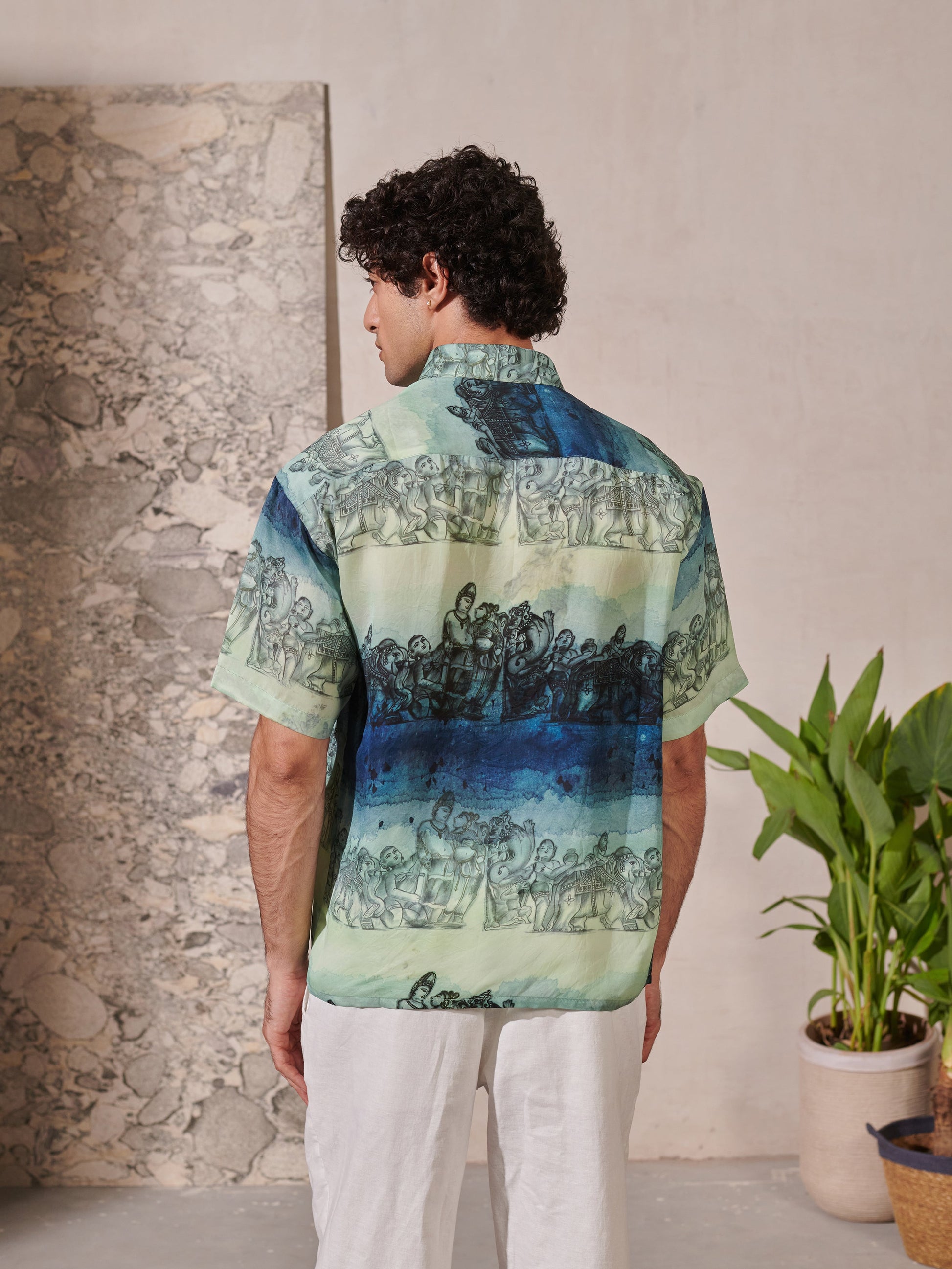 Back view of a Stylera relaxed fit short sleeve shirt for men in blue and green prints
