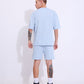 Stylera model wearing retro blue oversized t-shirt with matching shorts seen from back