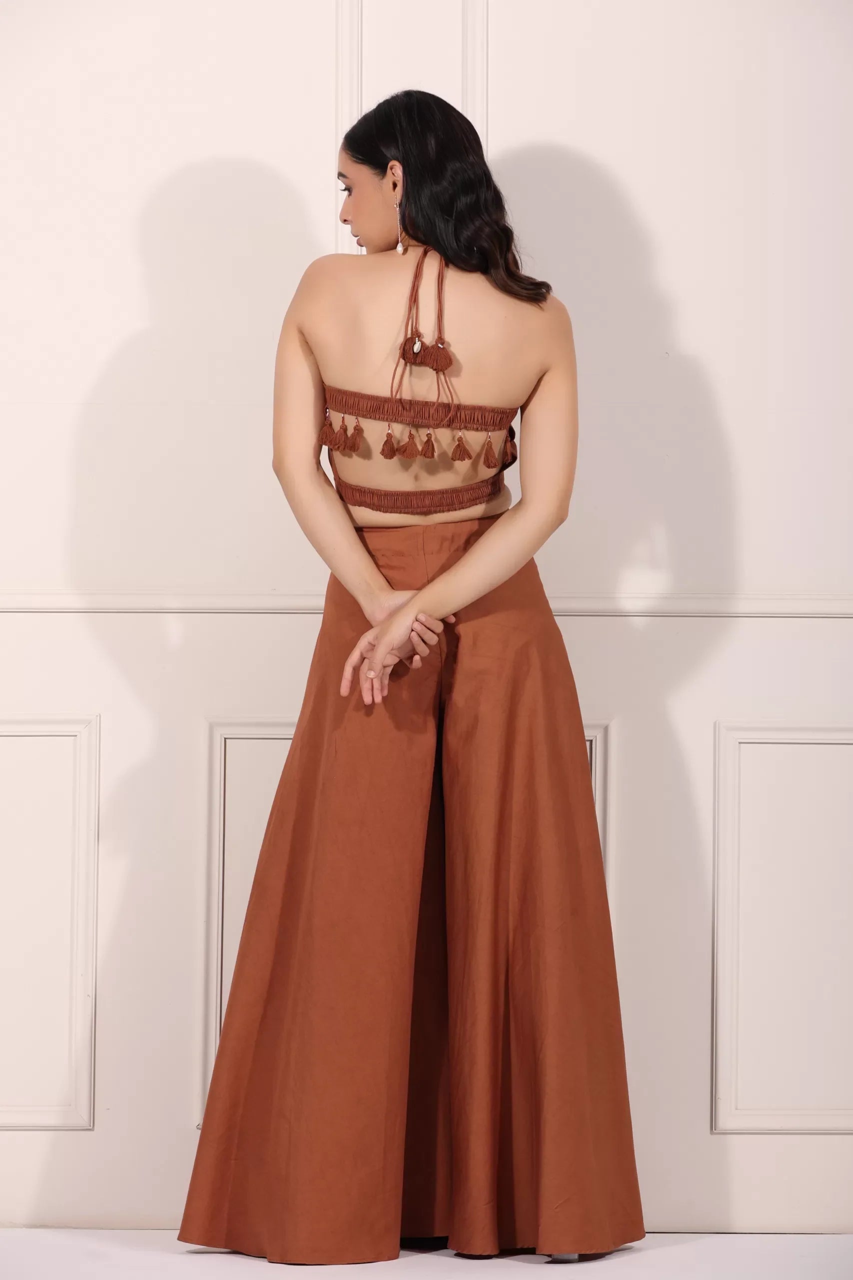 Back view of rust brown crop top and palazzo set with tassel detailing for a stylish summer look