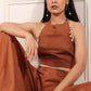 Model wearing a rust brown crop top and palazzo set with unique detailing for a stylish look