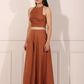 Model wearing a rust brown crop top and palazzo set, showcasing a stylish and elegant look