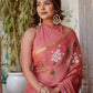 Elegant rust saree with floral hand painting, styled with statement earrings for a chic look