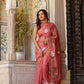 Elegant rust saree with floral hand painting, beautifully styled for traditional occasions