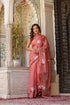 Elegant rust saree with floral hand painting, perfect for festive occasions and adding vibrant style to any wardrobe.