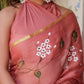 Elegant rust saree with floral hand painting and gold trim, styled for a sophisticated look