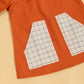 Rustic dress for fall outings in orange with checkered pocket details for a stylish look