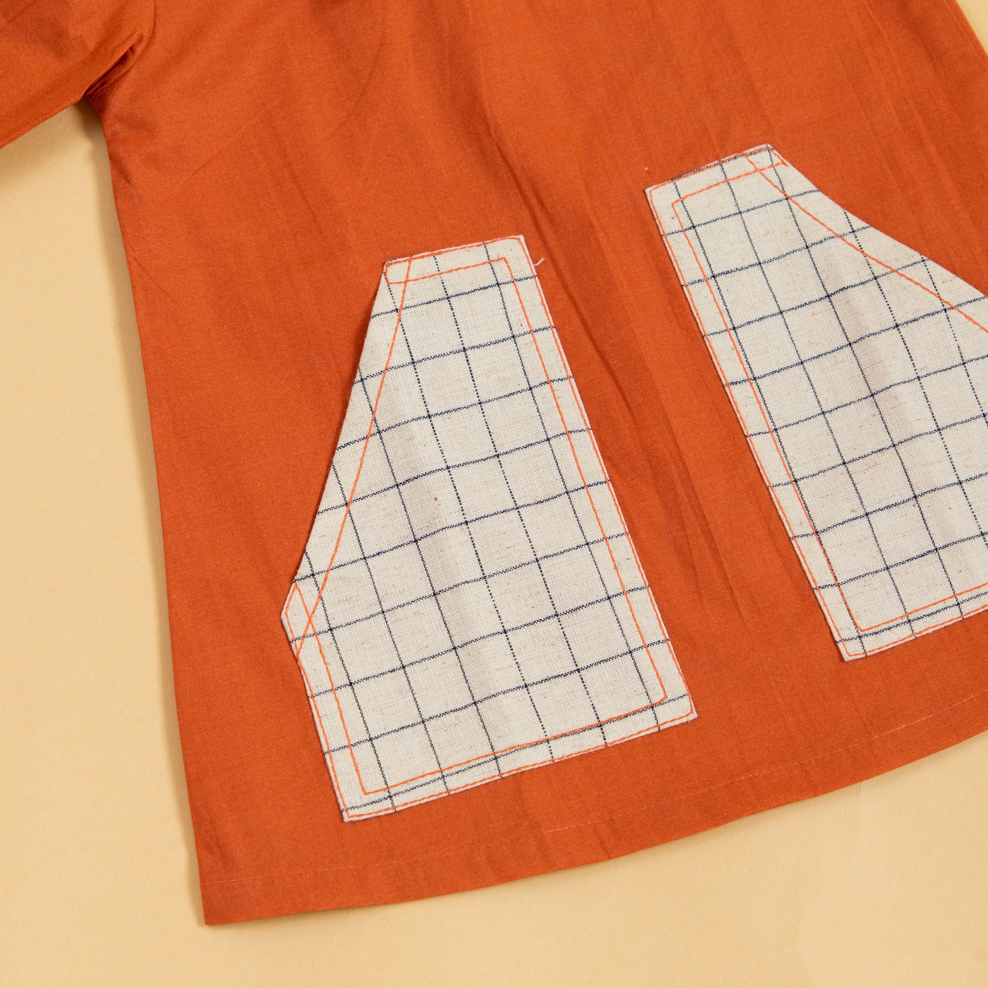 Rustic dress for fall outings in orange with checkered pocket details for a stylish look