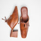 Brown slip-on block heel shoes by stylera with a low stacked heel and bow detail