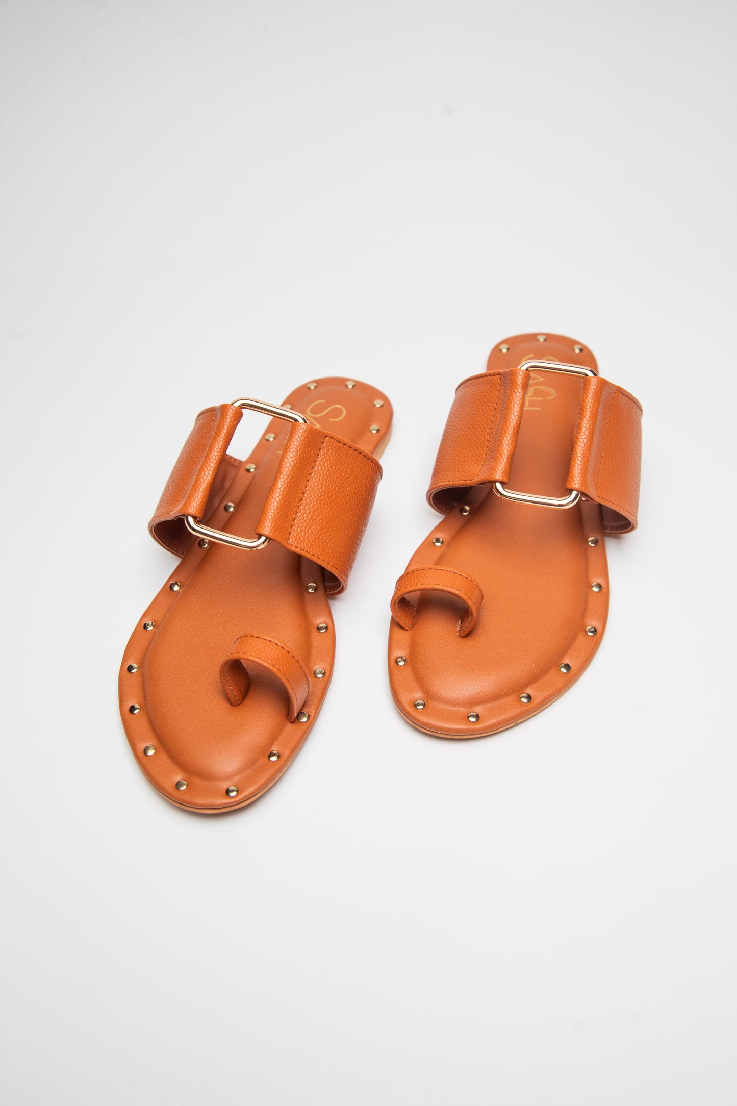 Stylera trendy leather flats for women in tan with toe loop and decorative buckle detail