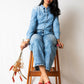 Stylera stylish red flat sandals worn by woman sitting on wooden stool with denim outfit