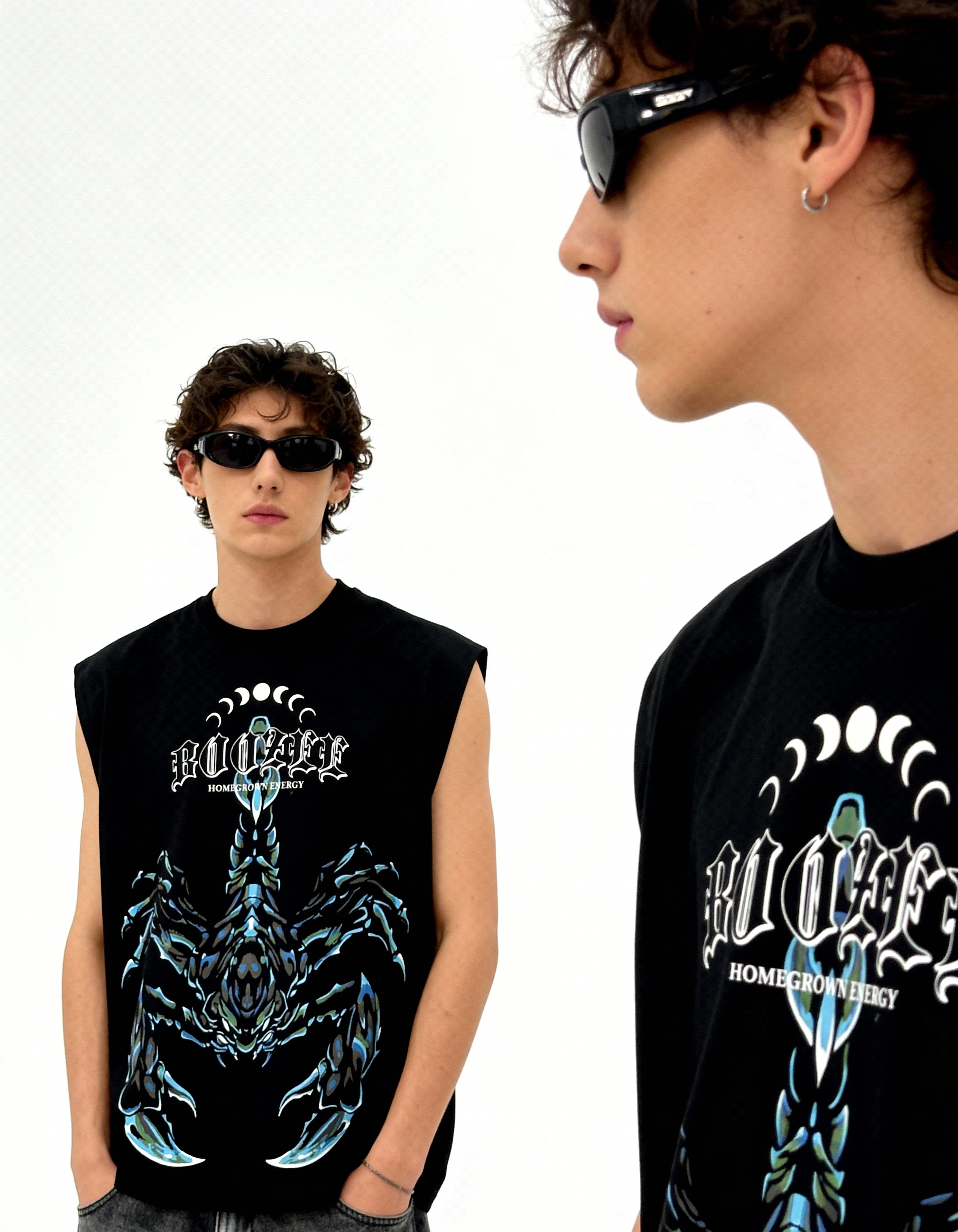 Two people wearing black sleeveless shirts with graphic designs on a white background