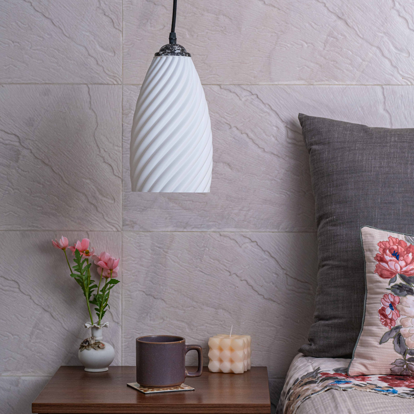 Sculpted white hanging lamp with a modern design illuminating a cozy living space