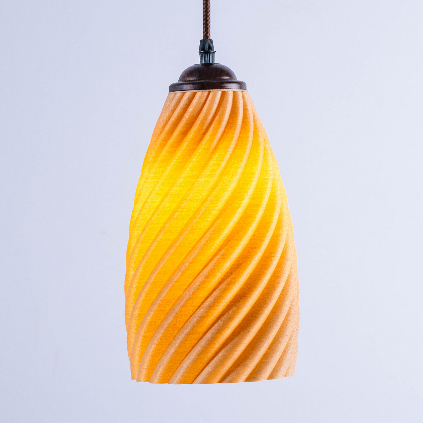 Orange sculpted white hanging lamp with a twisted design for modern home decor