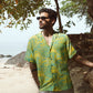 Men's seagreen oversize shirt for men featuring a colorful tropical print in a beach setting