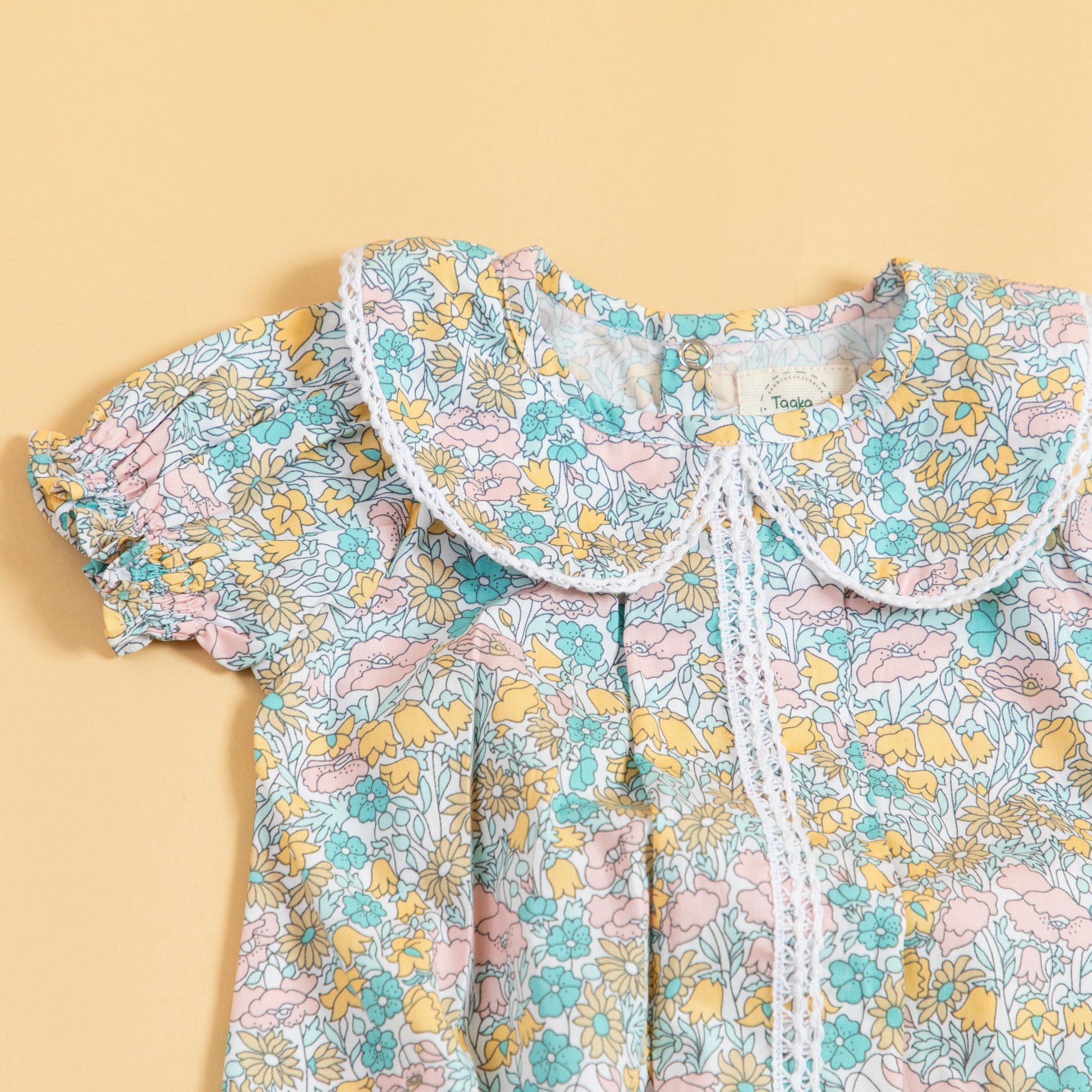 Colorful floral short sleeve baby romper with a cute collar design from Stylera