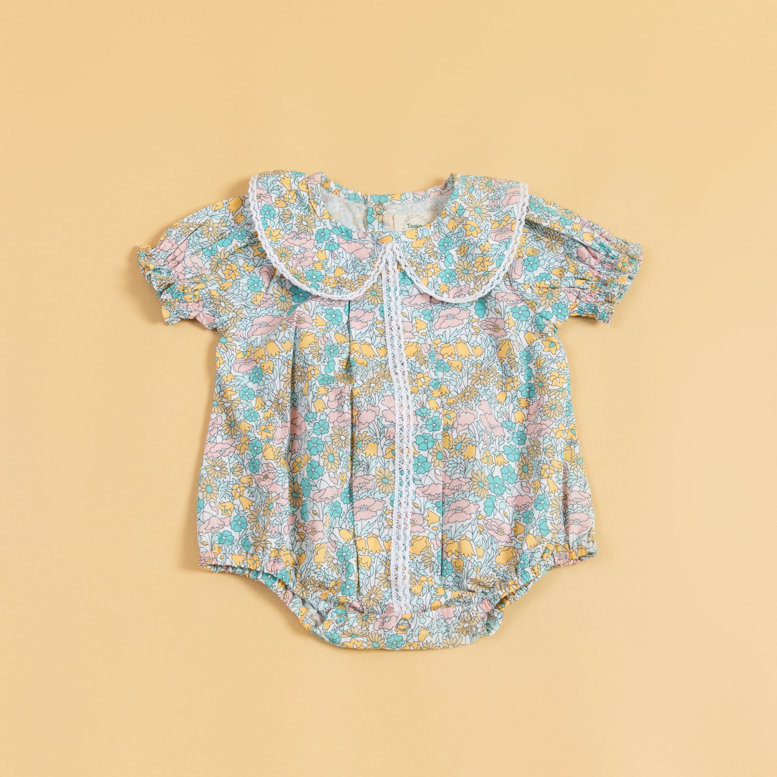 Floral Stylera short sleeve baby romper with a cute collar and button detailing