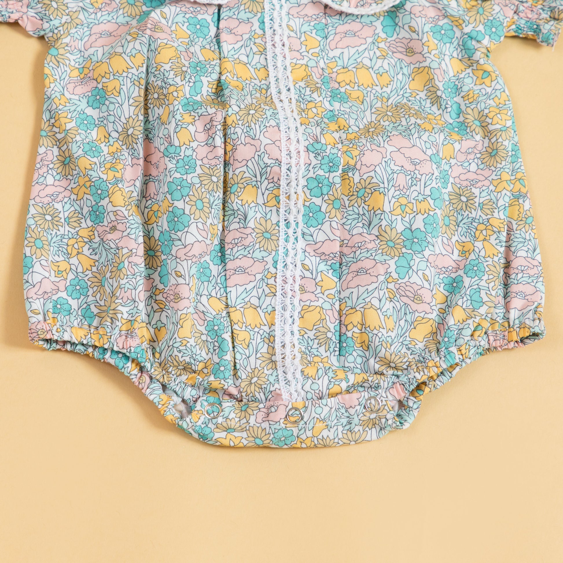Floral print short sleeve baby romper by Stylera in pastel colors for warm weather
