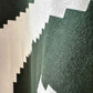 Stylera short sleeve streetwear tee close up of green cotton fabric with white pixelated zigzag graphic print