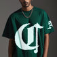Stylera dark green oversized short sleeve streetwear tee with large white pixelated logo worn by male model with chain