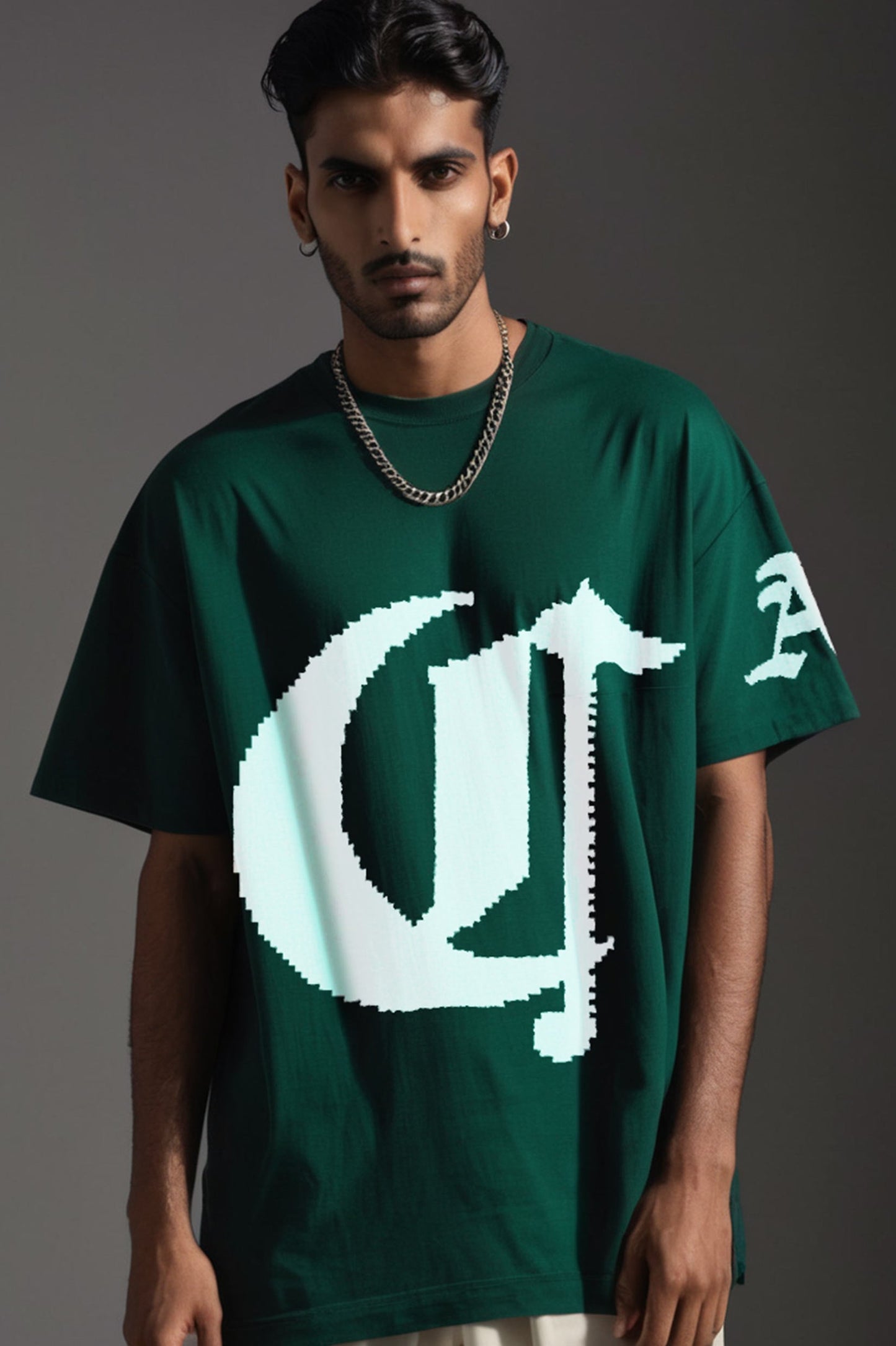 Stylera dark green oversized short sleeve streetwear tee with large white pixelated logo worn by male model with chain