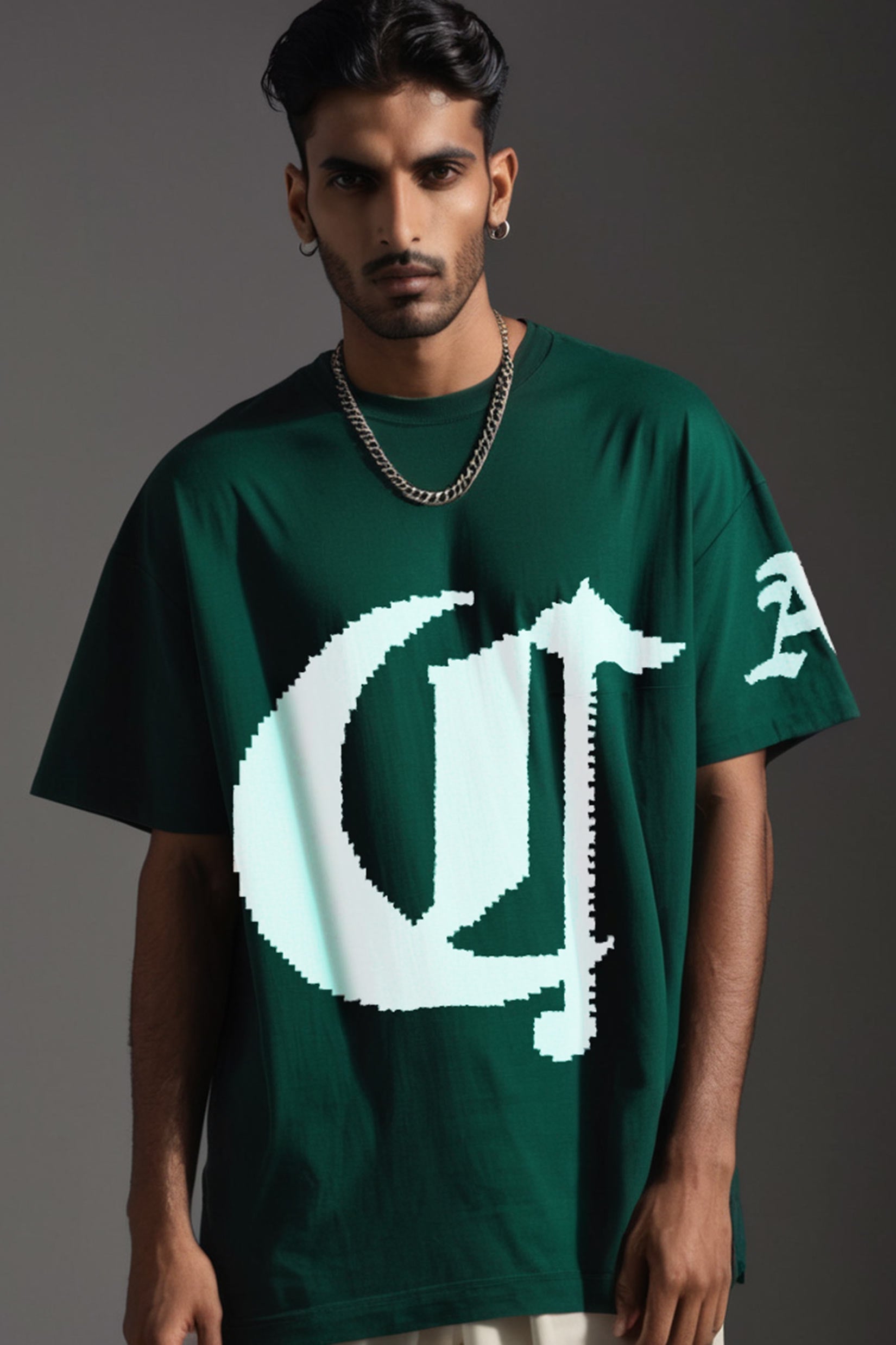 Stylera dark green oversized short sleeve streetwear tee with large white pixelated logo worn by male model with chain