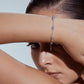 Stylera silver bean bracelet on model wrist with delicate chain and small bean beads
