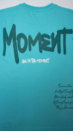 Stylstpls sky blue oversized t-shirt with bold 'Moment' graphic on the back