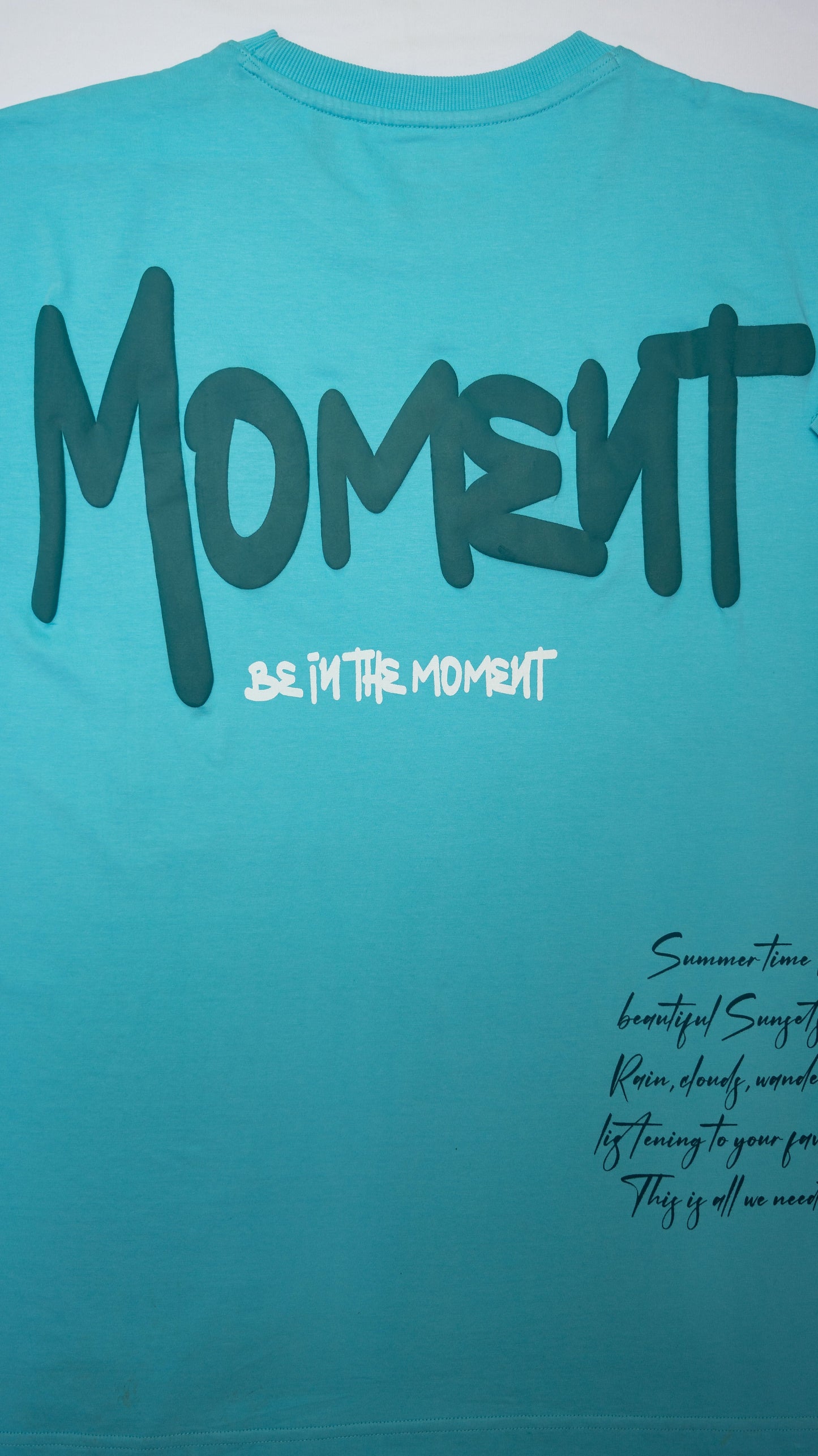 Stylstpls sky blue oversized t-shirt with bold 'Moment' graphic on the back