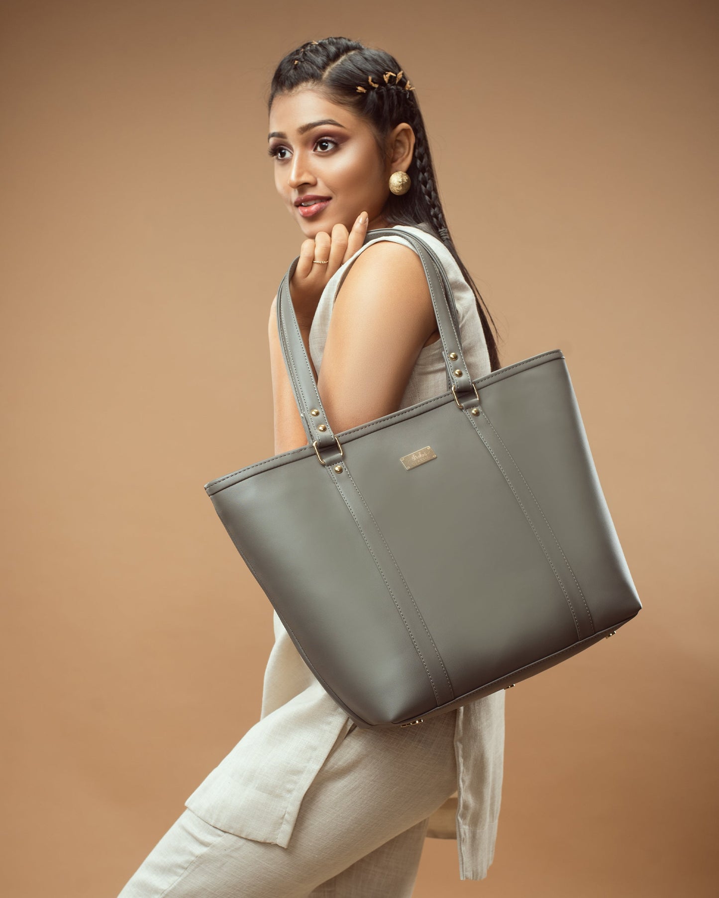 Stylish slate grey tote bag showcased by model with elegant outfit in minimalist setting