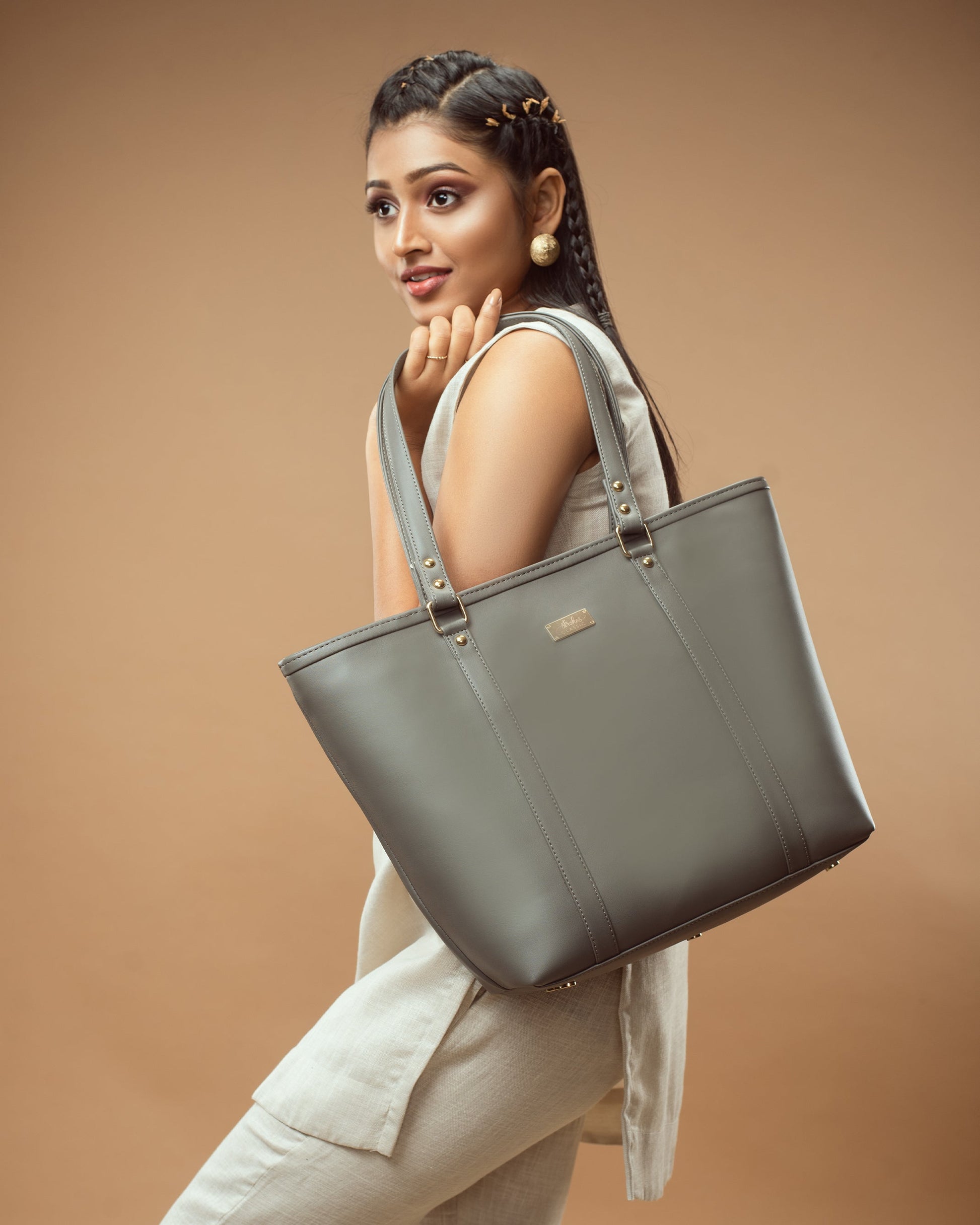 Stylish slate grey tote bag showcased by model with elegant outfit in minimalist setting