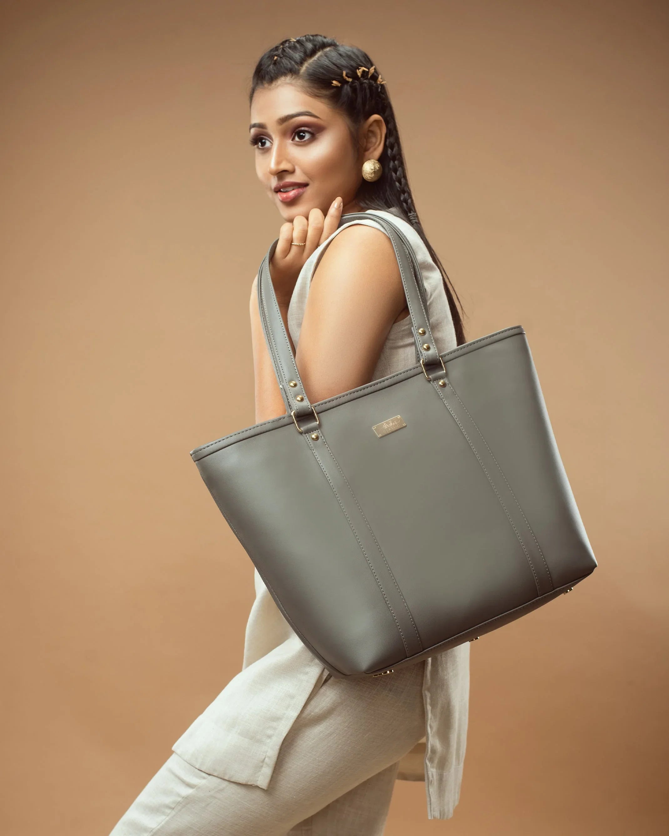 Stylish slate grey tote bag showcased by model with elegant outfit in minimalist setting