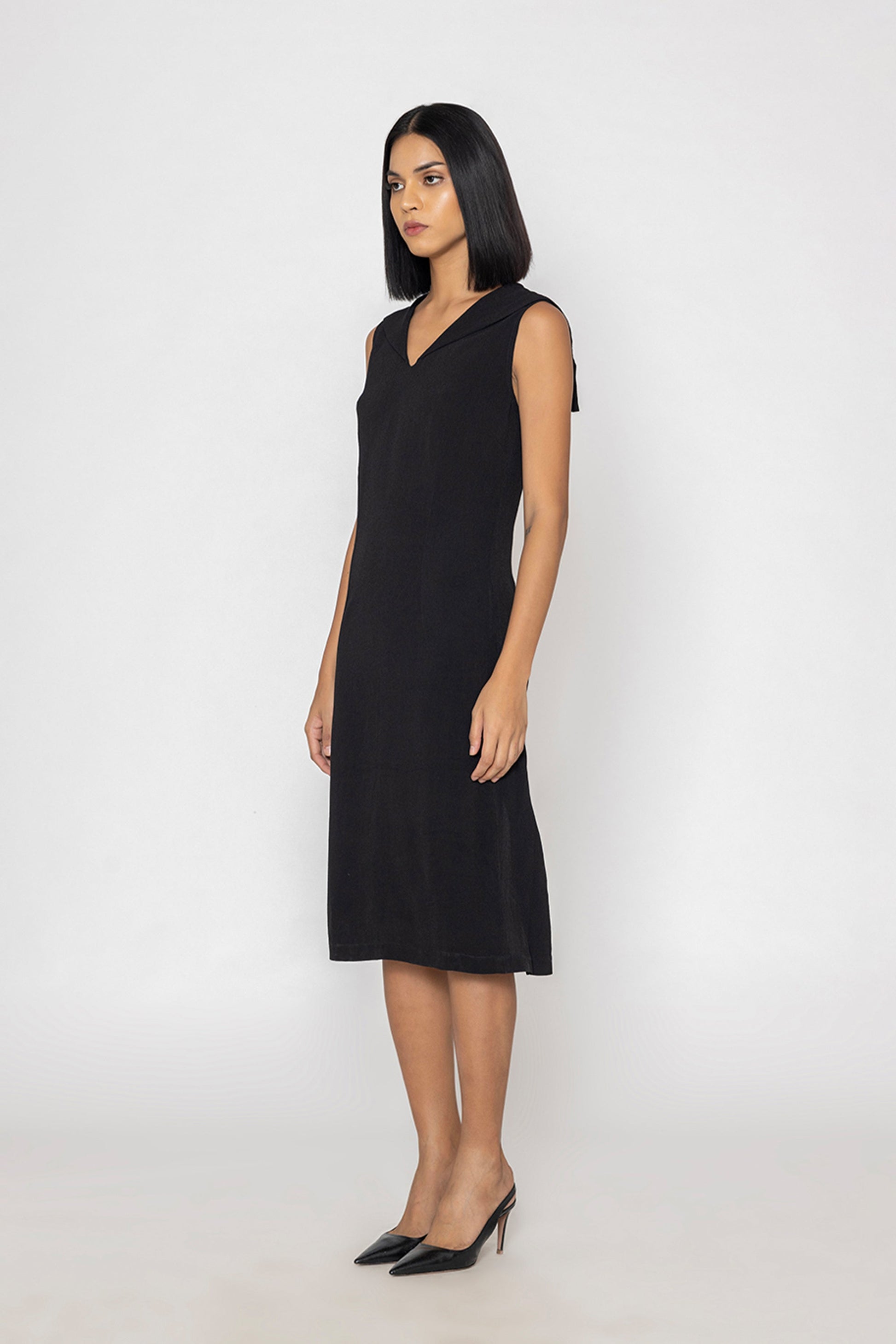 Stylera sleek black evening dress sleeveless V-neck midi length on model