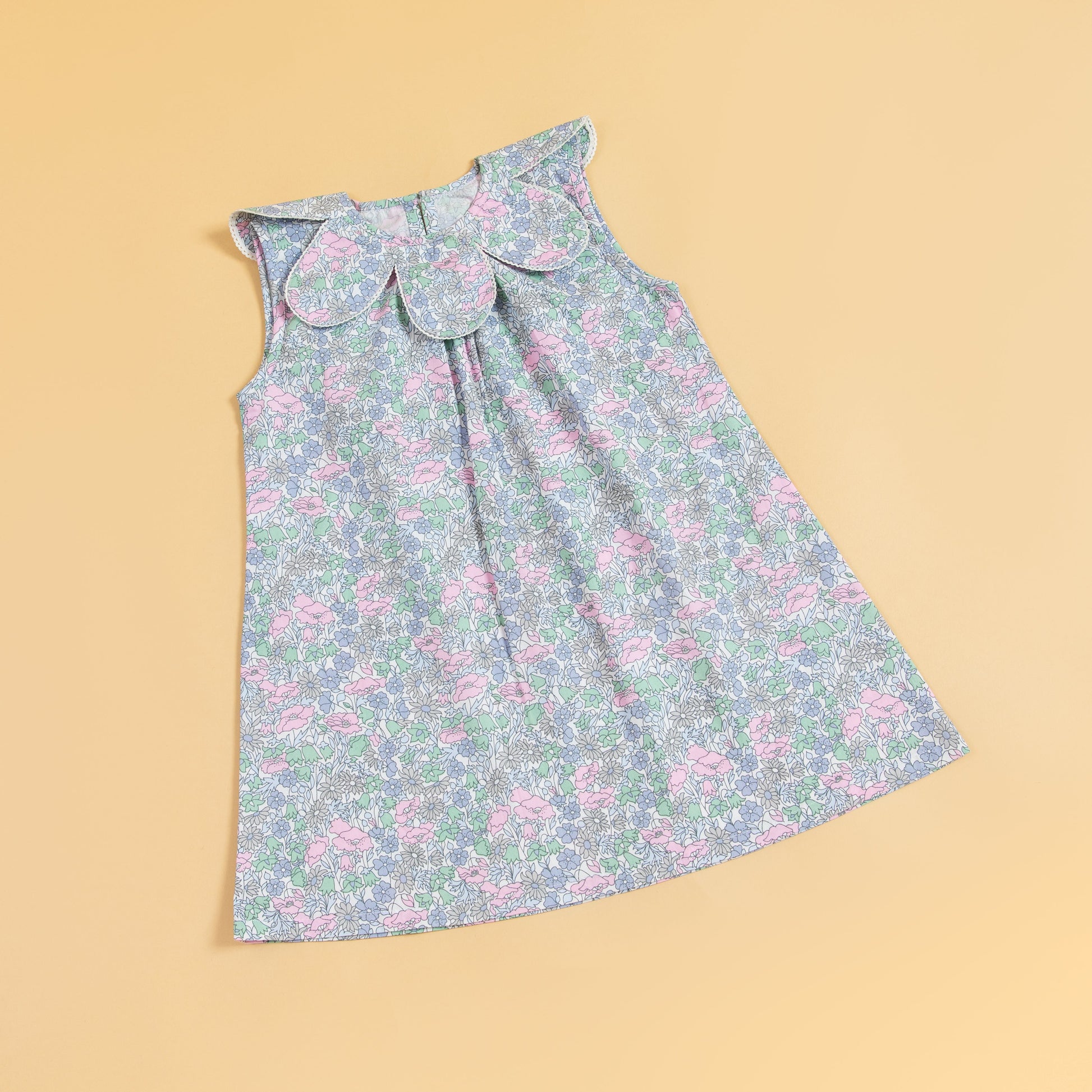 Stylera sleeveless floral print dress in pastel colors with an elegant round collar design