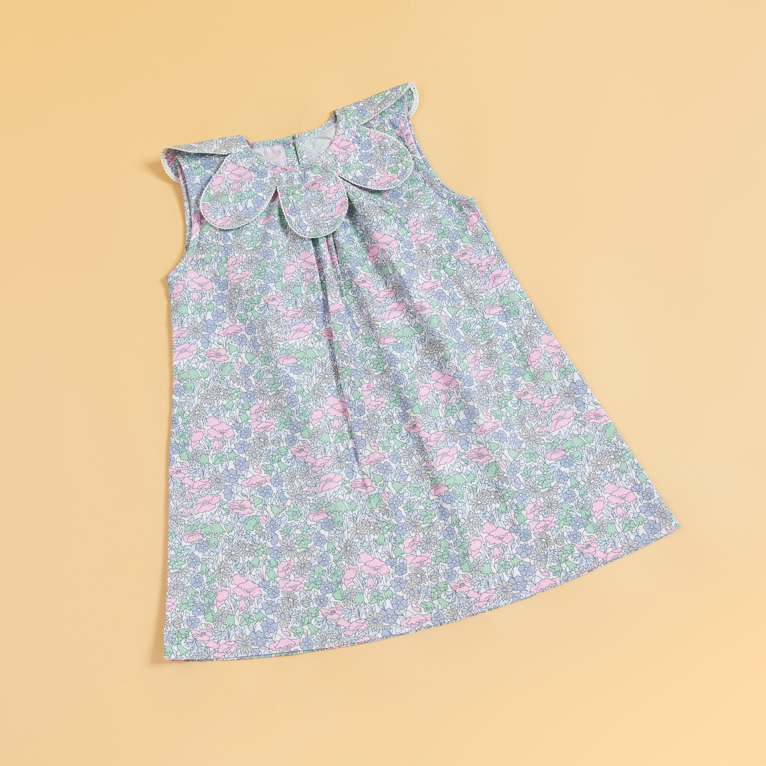 Stylera sleeveless floral print dress in pastel colors with an elegant round collar design