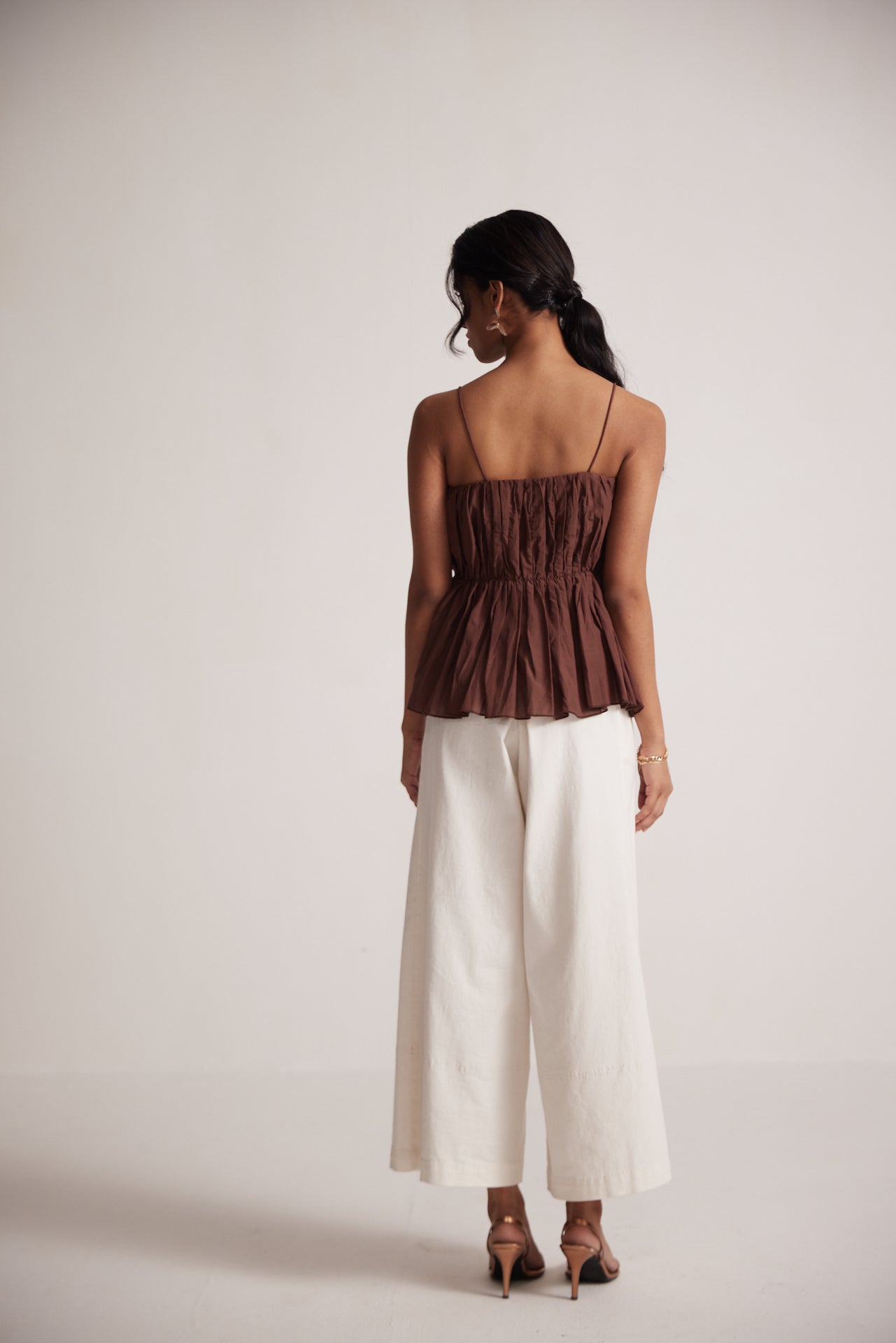 Stylera sleeveless peplum blouse for women in brown with ruched back and thin straps