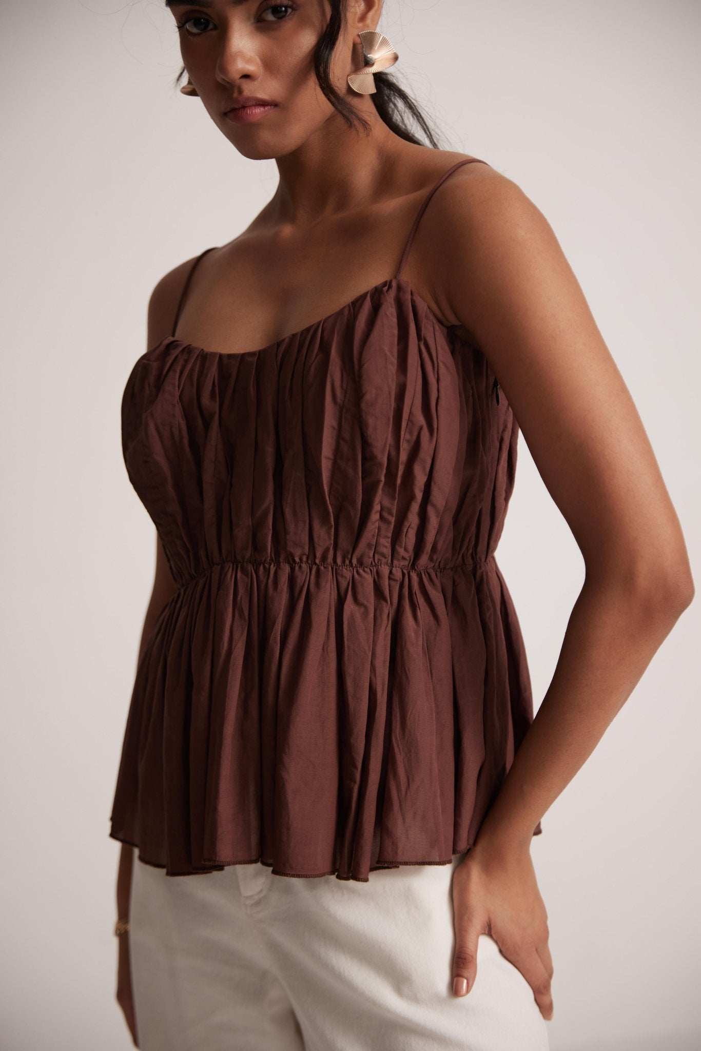 Stylera sleeveless peplum blouse for women in brown with thin straps and gathered waist detail