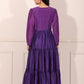 Back view of a solid purple flowy dress for women with long sleeves and tiered design