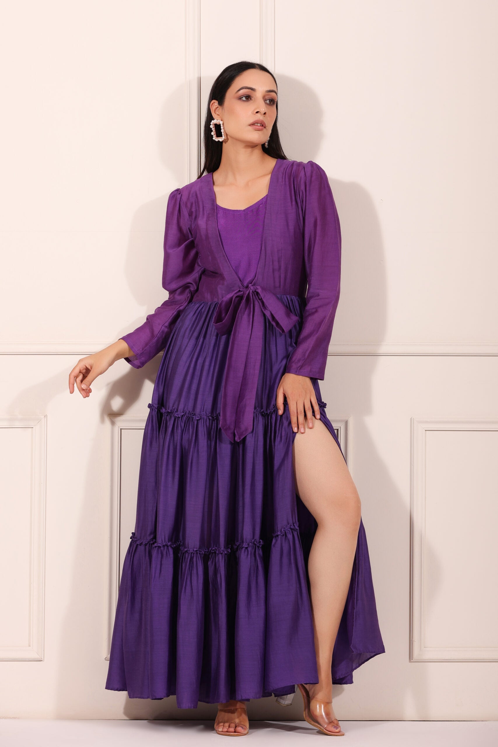Elegant solid purple flowy dress for women with a stylish tie waist and tiered skirt design