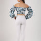 Back view of Stylera statement sleeve crop top with floral print and puff sleeves paired with white pants