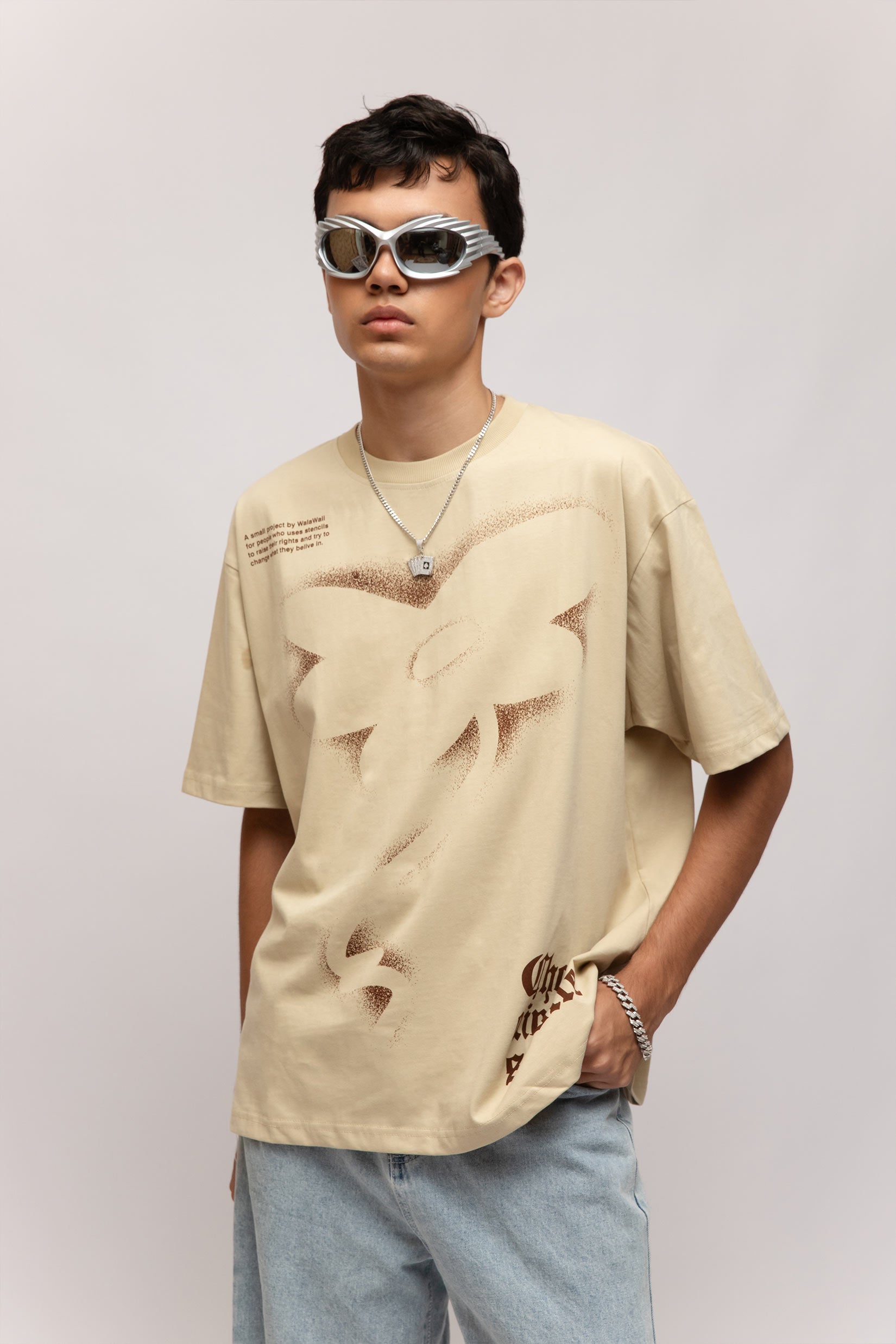 Stylera beige oversized stencil art t-shirt with abstract cutout print worn by male model