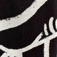 Stylera black T shirt close up showing white brushstroke abstract print on fabric trendy oversized art tee for men