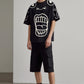Stylera black oversized t shirt with white abstract face print paired with cargo shorts trendy oversized art tee for men