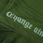 Stylera olive green cargo pocket joggers closeup showing folded fabric seam and white gothic text print on leg