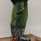 Stylera green cargo pocket joggers side view with pencil in pocket paired with graffiti boots on rug