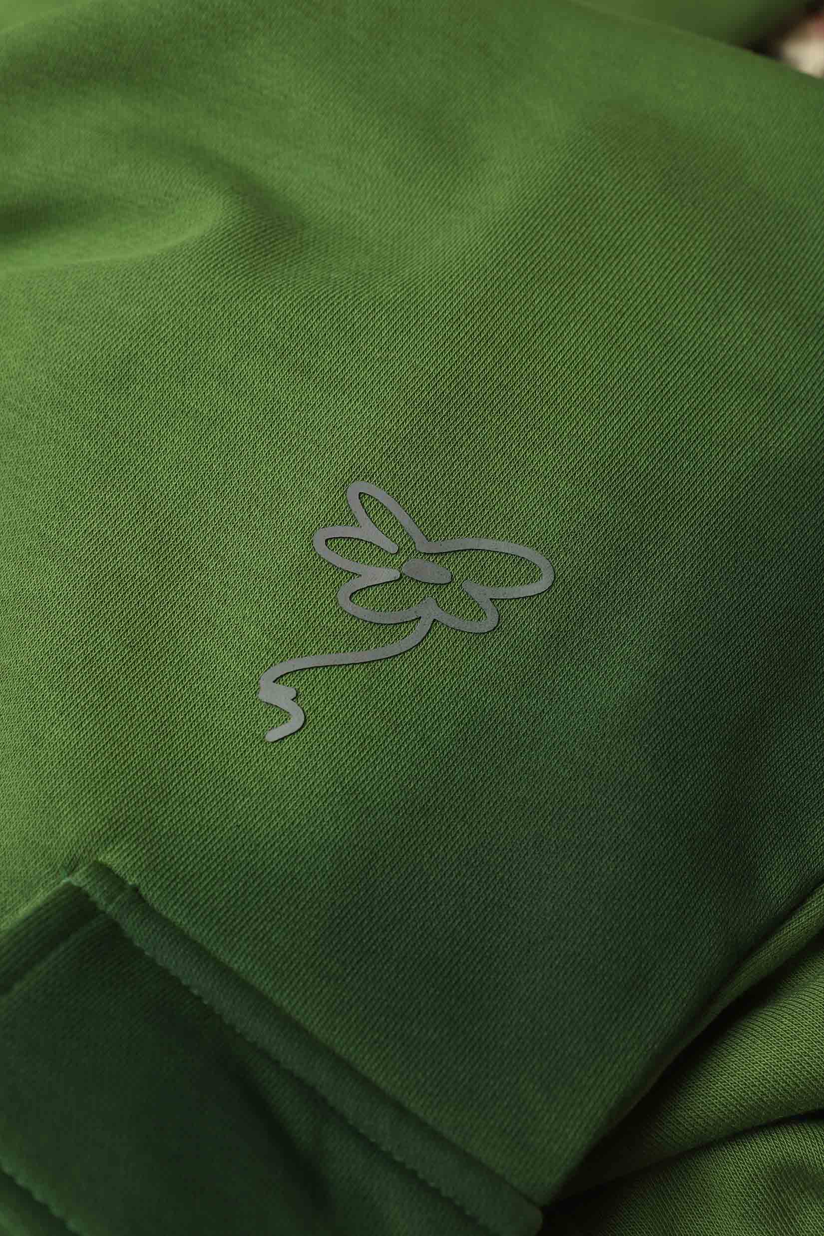 Stylera green cargo pocket joggers close up showing fabric texture pocket edge and brand logo